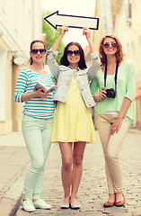 Image showing smiling teenage girls with white arrow outdoors