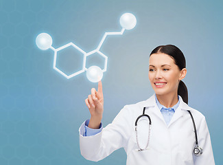 Image showing smiling female doctor pointing to molecule