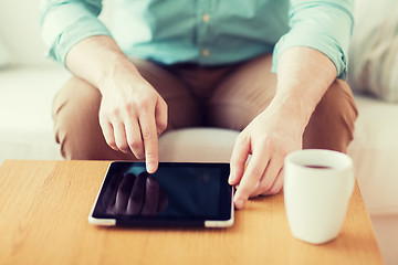 Image showing close up of man with laptop and cup at home