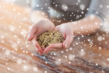 Image showing female with white and wild black rice on palm