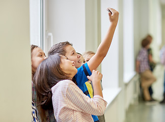 Image showing group of school kids taking selfie with smartphone