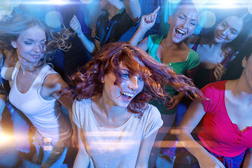 Image showing smiling friends dancing in club