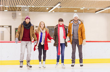 Image showing happy friends on skating rink