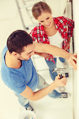 Image showing smiling couple renovating new home