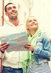 Image showing happy couple with map exploring city