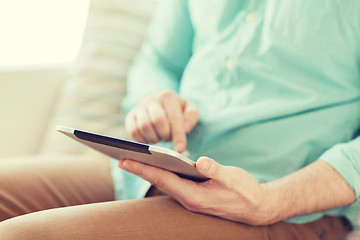 Image showing close up of man with tablet pc computer at home