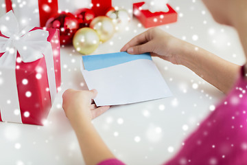 Image showing close up of woman with letter and presents