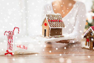 Image showing close up of woman showing gingerbread house