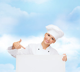 Image showing smiling female chef with white blank board