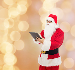 Image showing man in costume of santa claus with tablet pc