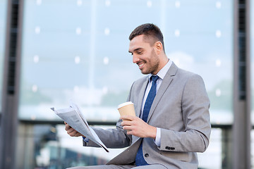 Image showing young businessman with coffee and newspaper