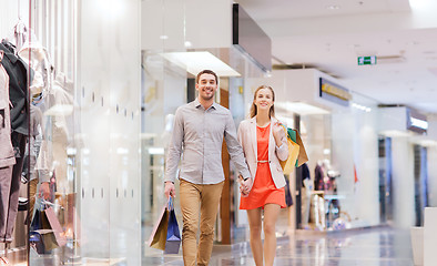 Image showing happy young couple with shopping bags in mall