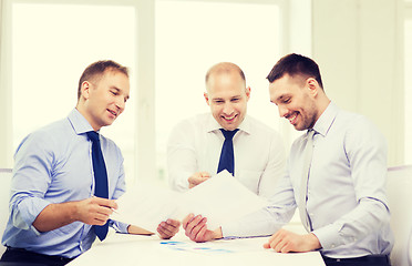 Image showing smiling businessmen with papers in office