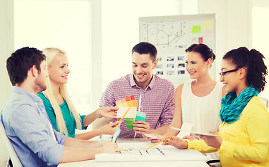 Image showing smiling interior designers working in office