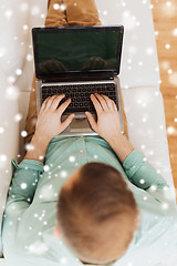 Image showing close up of man working with laptop at home