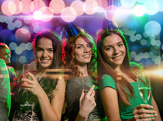 Image showing smiling friends with glasses of champagne in club