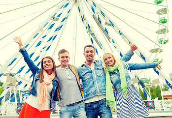 Image showing group of smiling friends waving hands