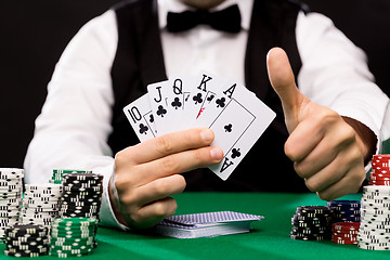 Image showing poker player with cards and chips at casino