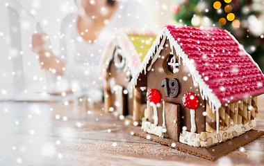 Image showing close up of woman making gingerbread houses