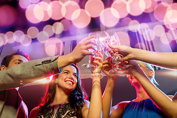 Image showing smiling friends with glasses of champagne in club