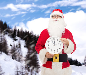 Image showing man in costume of santa claus with clock