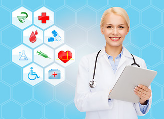 Image showing smiling doctor with tablet pc and medical symbols