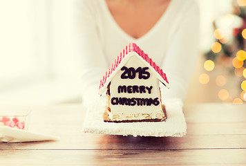 Image showing close up of woman showing gingerbread house