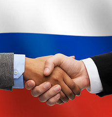 Image showing close up of handshake over russian flag