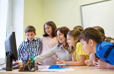 Image showing group of kids with teacher and computer at school