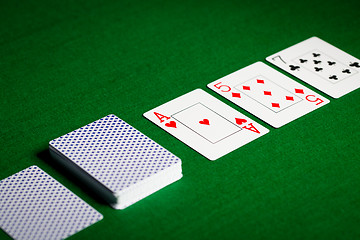 Image showing playing cards on green table surface