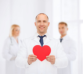 Image showing smiling male doctor with red heart