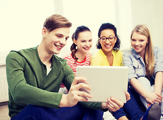 Image showing smiling students making picture with tablet pc