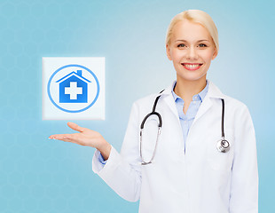 Image showing smiling doctor or nurse pointing to pills icon