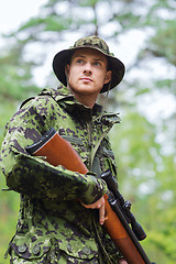 Image showing young soldier or hunter with gun in forest