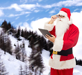 Image showing man in costume of santa claus with tablet pc