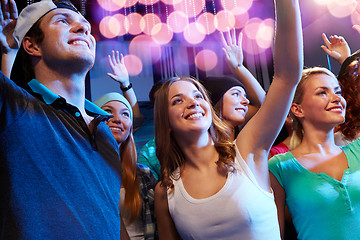 Image showing smiling friends at concert in club