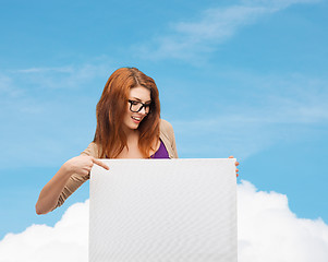 Image showing smiling teenage girl in glasses with white board