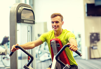 Image showing smiling man exercising in gym