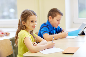 Image showing group of school kids writing test in classroom