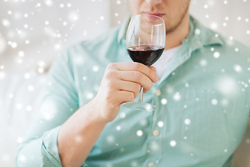 Image showing close up of man drinking red wine at home