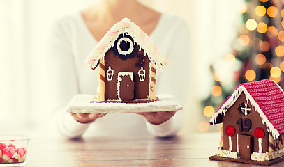 Image showing close up of woman showing gingerbread house