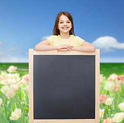 Image showing happy little girl with blank blackboard