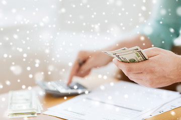 Image showing close up of man counting money and making notes