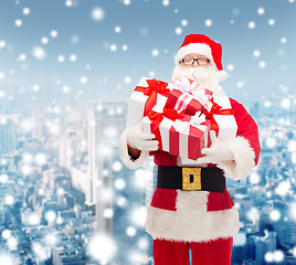 Image showing man in costume of santa claus with gift boxes