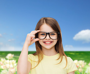 Image showing smiling cute little girl in black eyeglasses