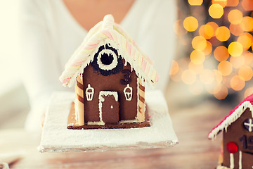 Image showing close up of woman showing gingerbread house