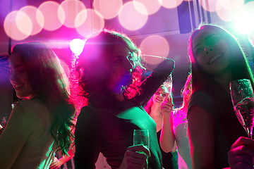 Image showing smiling friends with glasses of champagne in club