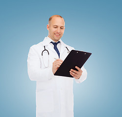 Image showing smiling male doctor with clipboard and stethoscope