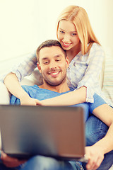 Image showing smiling happy couple with laptop at home