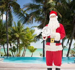 Image showing man in costume of santa claus with clock